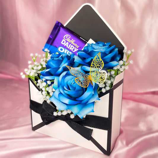 Stunning Envelope Style Chocolate & Flower Arrangement - Inc. Cadbury Oreo Chocolate Bar, 3x Blue Forever Roses & Personalised Postcard