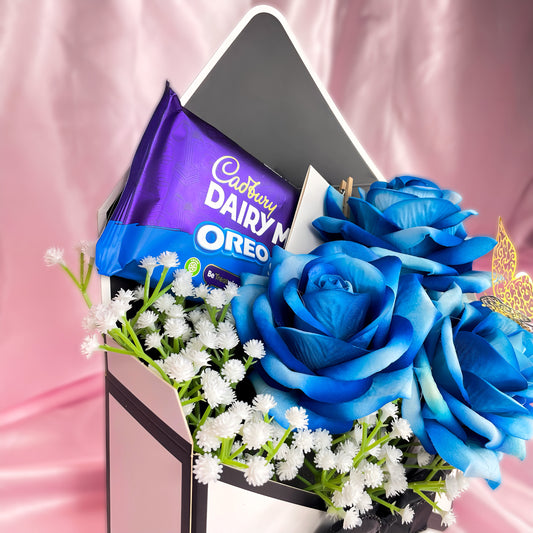 Stunning Envelope Style Chocolate & Flower Arrangement - Inc. Cadbury Oreo Chocolate Bar, 3x Blue Forever Roses & Personalised Postcard