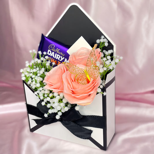 Stunning Envelope Style Chocolate & Flower Arrangement - Inc. Cadbury Hazelnut Chocolate Bar, 3x Pink Forever Roses & Personalised Postcard