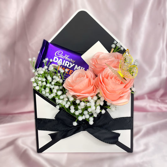 Stunning Envelope Style Chocolate & Flower Arrangement - Inc. Cadbury Hazelnut Chocolate Bar, 3x Pink Forever Roses & Personalised Postcard